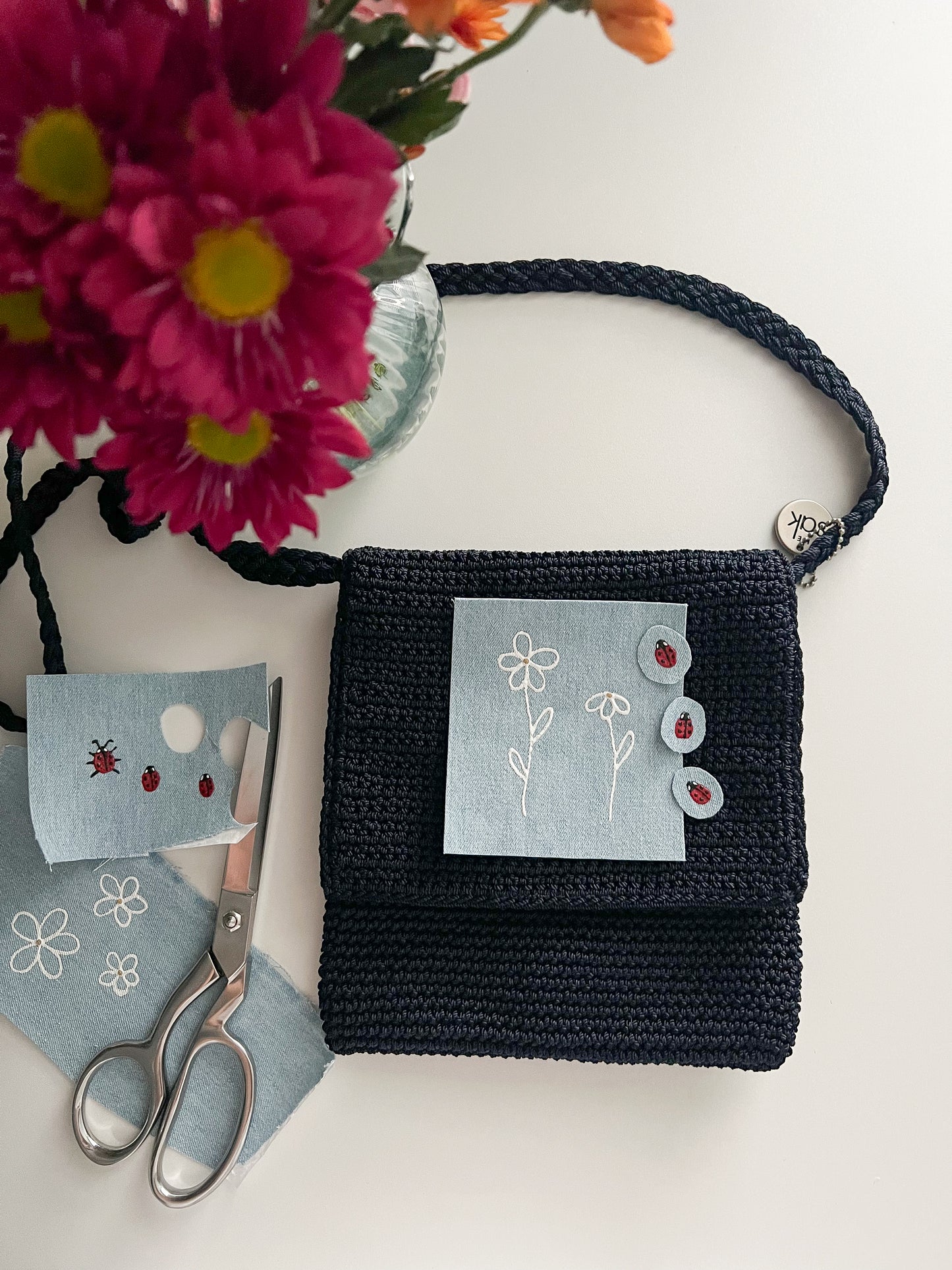 Reworked hand-painted flowers and ladybugs appliqué The Sack bag