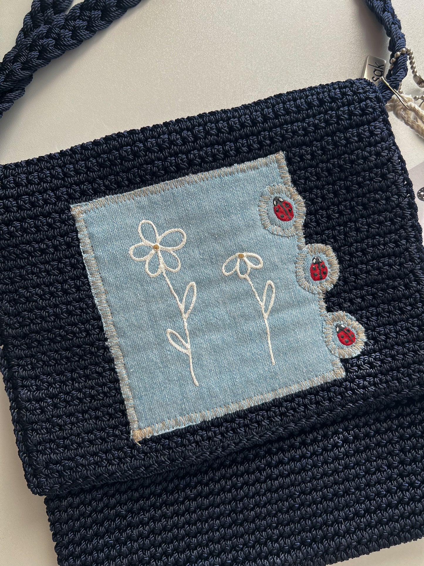 Reworked hand-painted flowers and ladybugs appliqué The Sack bag